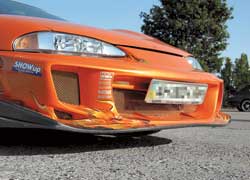 Mitsubishi Eclipse. Экстерьер усовершенствован при помощи пакета обвеса Bomex Aero, включающего пару бамперов и пару накладок на пороги. Своим умопомрачительным цветом машина обязана японской перламутровой краске Maziora Orange.